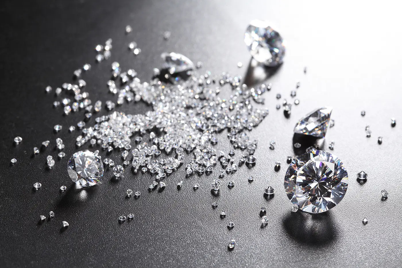 Loose diamond particles displayed in different carat sizes from Joe Kassab Jewelers