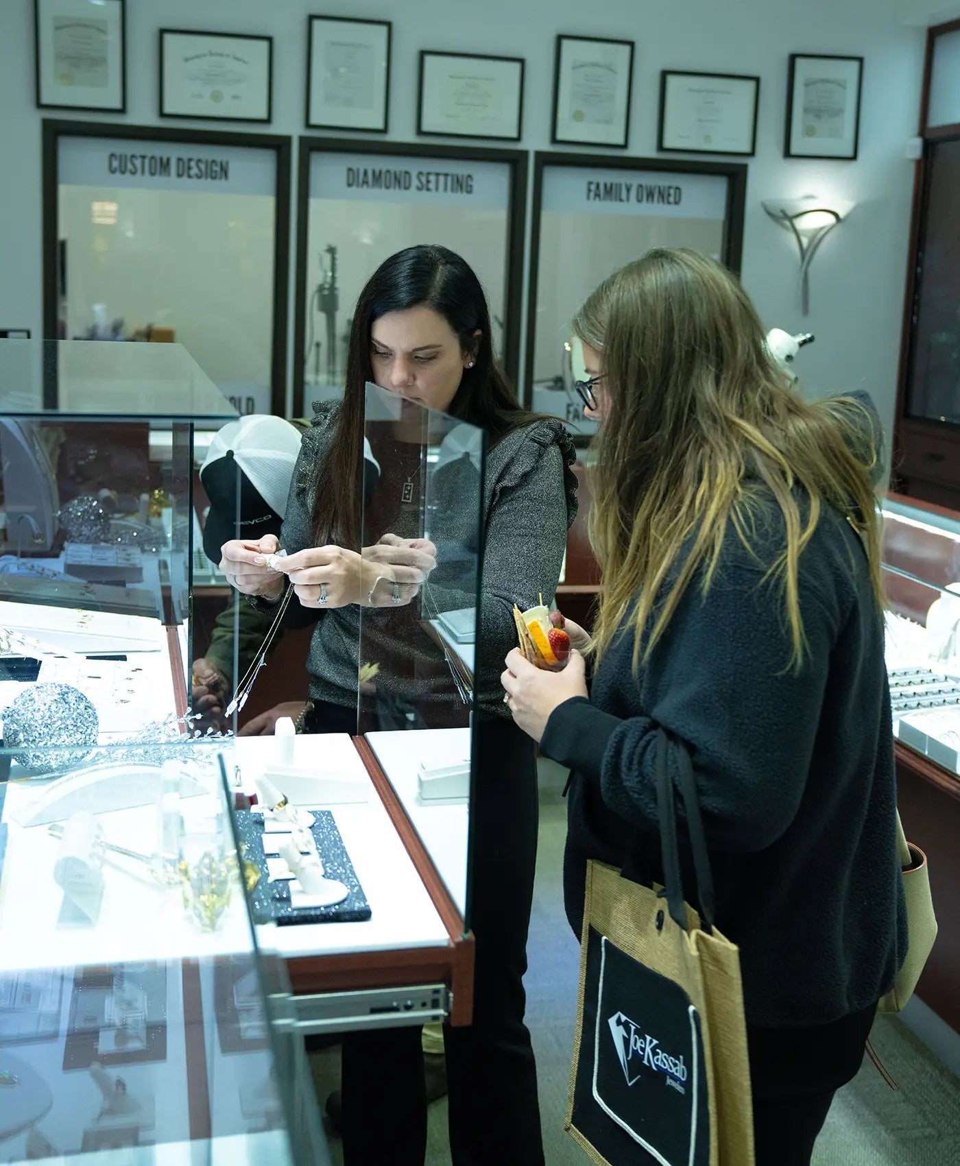 Two women looking into a jewelry display case at Joe Kassab Jewelers in Happy Valley, Oregon