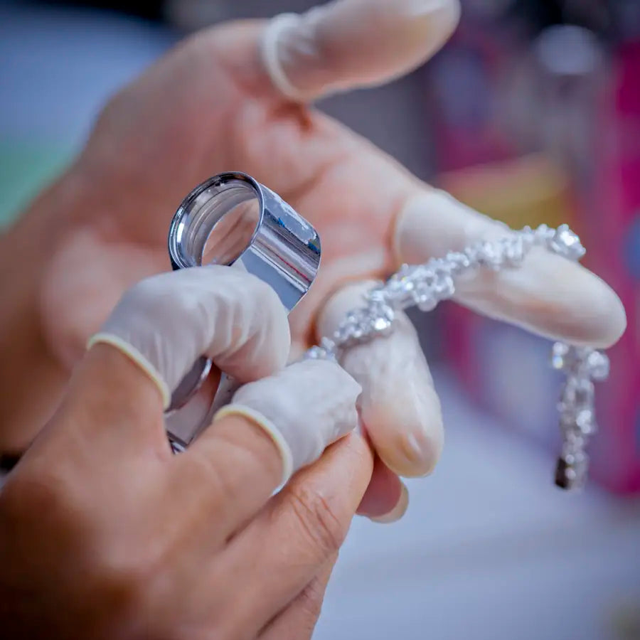 Jeweler appraising diamond necklace at Joe Kassab Jewelers in Happy Valley, Oregon