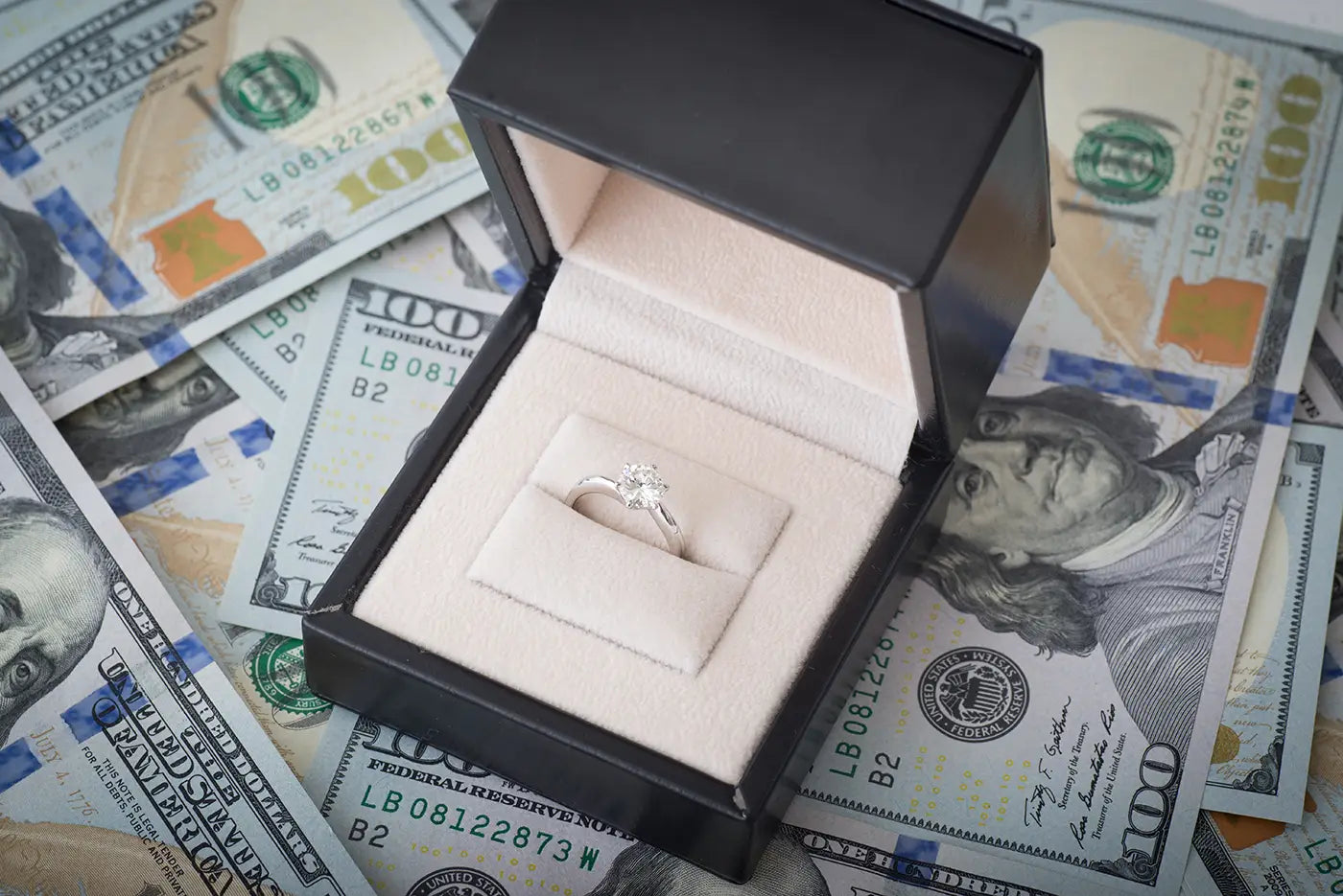 Black box containing diamond ring on cash, symbolizing layaway plan at Joe Kassab Jewelers