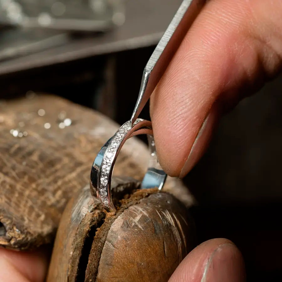 Jeweler performing prong repair and tightening stones on a ring at Joe Kassab Jewelers