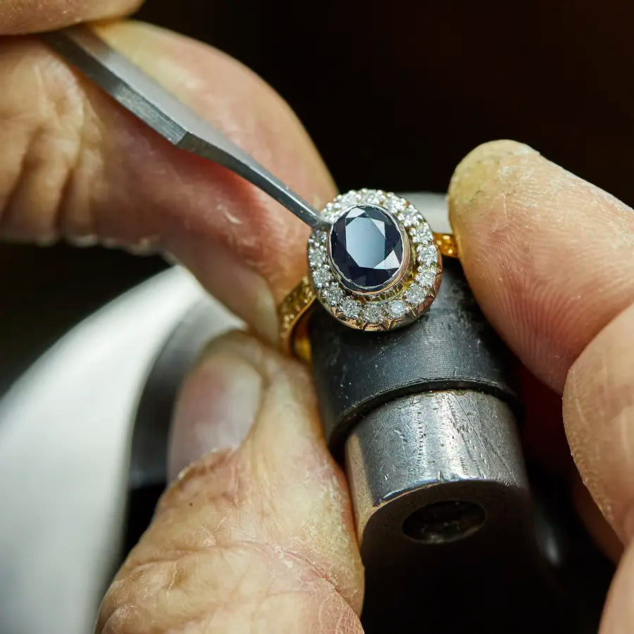 Professional repairing a ring with precision jewelry tools at Joe Kassab Jewelers in Happy Valley, Oregon